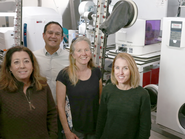 UC Santa Barbara collaborators (left to right) Michelle O’Malley, Ty Vernon, Jean Carlson, and Elaine Kirschke stand in the NSF ExFAB Biofoundry, a state-of-the- art facility central to the university’s newly awarded project.